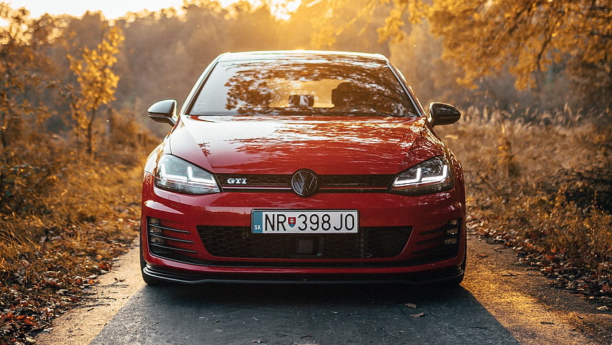 Red Volkswagen Golf GTI Front View on Autumn Country Road at Golden Hour HD wallpaper