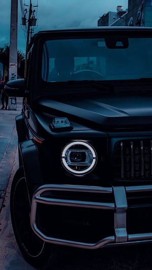 Matte Black Mercedes-AMG G63 G-Wagon Front Grille and Headlight Detail at Dusk HD phone wallpaper