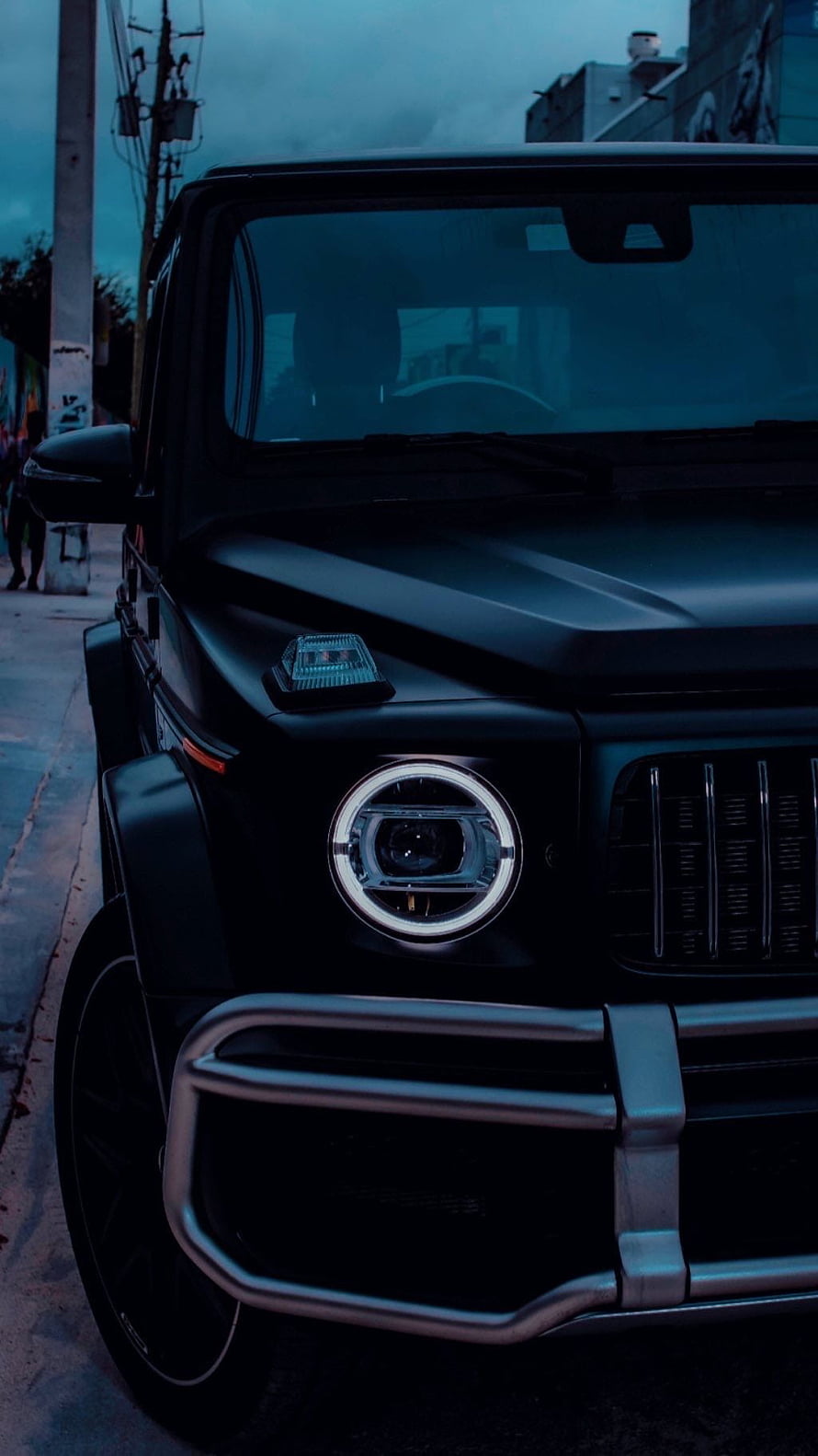 Matte Black Mercedes-AMG G63 G-Wagon Front Grille and Headlight Detail at Dusk HD phone wallpaper