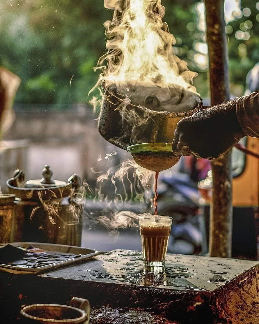 Street Vendor Pouring Steaming Indian Chai from a Traditional Metal Pot HD phone wallpaper