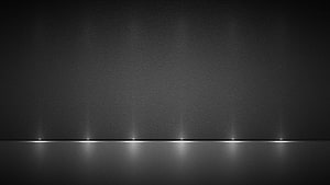 Minimalist Dark Stage with Recessed Floor Lighting and Textured Wall Surface HD wallpaper