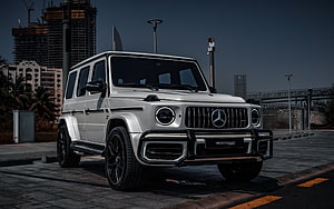 White Mercedes-Benz G63 AMG SUV with Urban Cityscape Background HD wallpaper