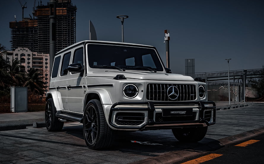 White Mercedes-Benz G63 AMG SUV with Urban Cityscape Background HD wallpaper