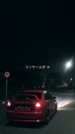 Red Mitsubishi Lancer Evolution IV parked on a dark street at night with glowing taillights HD phone wallpaper