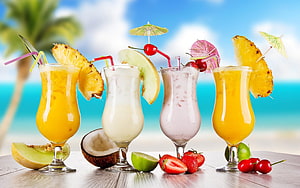 Tropical Fruit Smoothies with Pineapple and Coconut on a Beach Table HD wallpaper