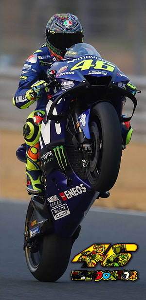 Valentino Rossi performing a wheelie on his Yamaha MotoGP race bike HD phone wallpaper