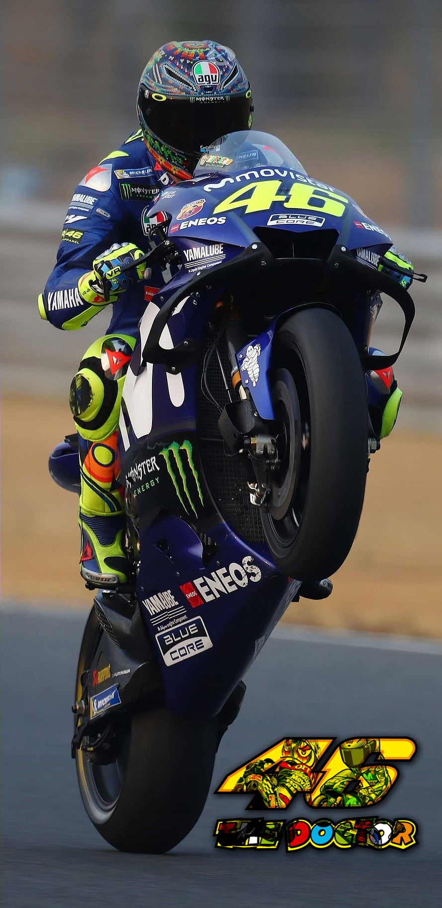 Valentino Rossi performing a wheelie on his Yamaha MotoGP race bike HD phone wallpaper