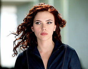 Scarlett Johansson as Black Widow in a dark jacket with windswept red hair HD wallpaper