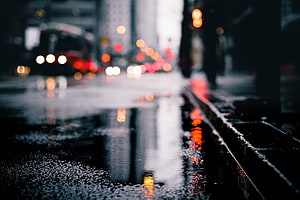 Moody Rainy City Street with Bokeh Lights and Wet Pavement Reflections HD wallpaper