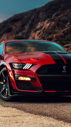 Red Ford Mustang Shelby GT500 with Black Racing Stripes on a Mountain Road HD phone wallpaper