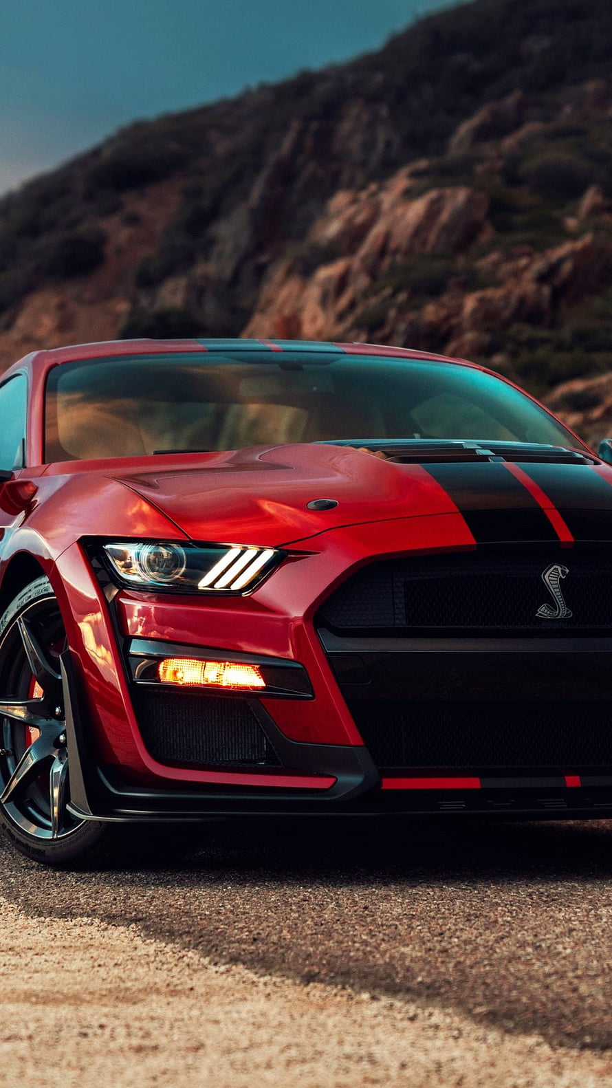 Red Ford Mustang Shelby GT500 with Black Racing Stripes on a Mountain Road HD phone wallpaper