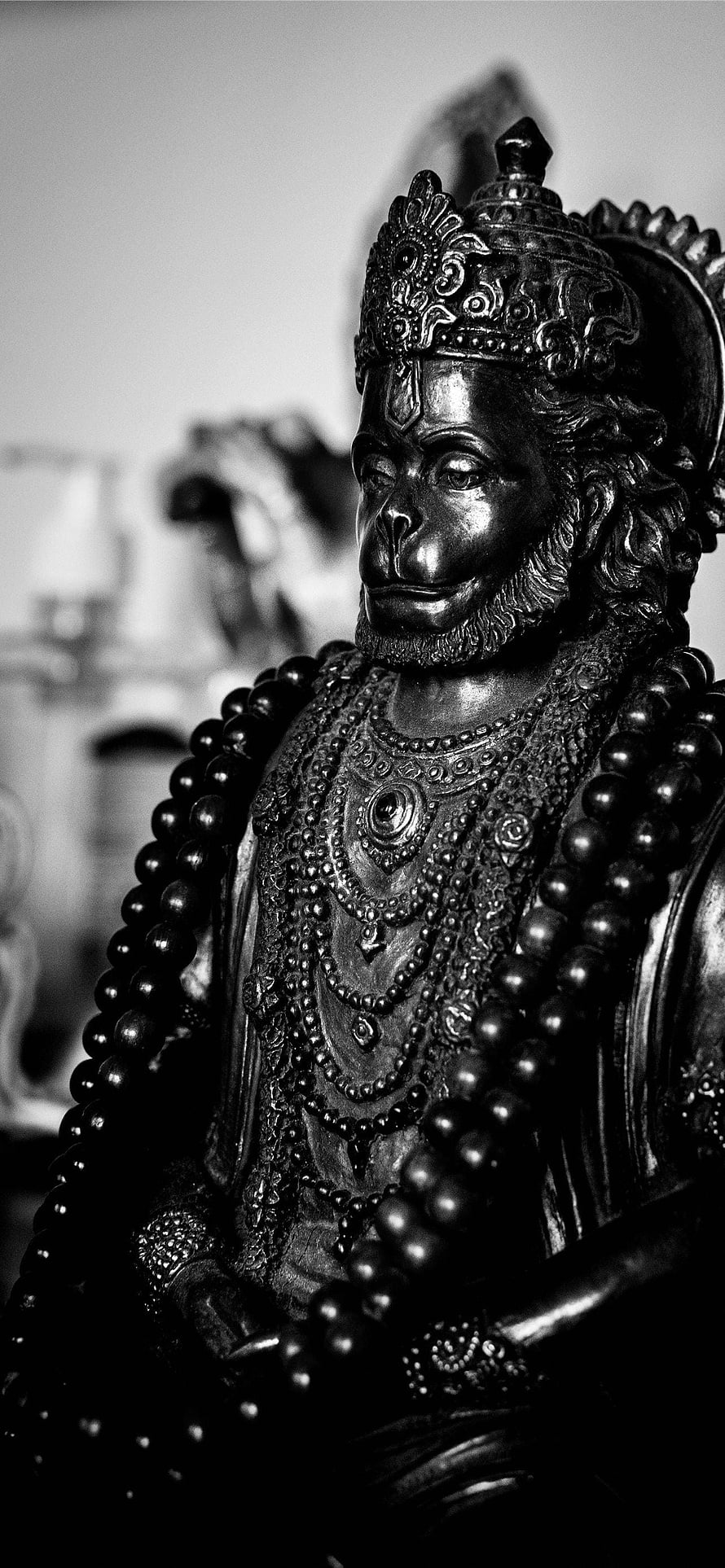 Black and White Hanuman Idol Statue with Ornate Crown and Beaded Garlands HD phone wallpaper