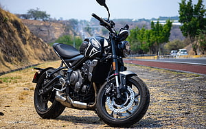 Black Triumph Trident 660 Motorcycle Parked on Gravel Shoulder HD wallpaper