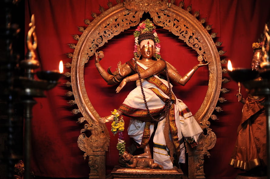 Nataraja Dancing Shiva Statue in Chidambaram Temple with Oil Lamps and Red Backdrop HD wallpaper