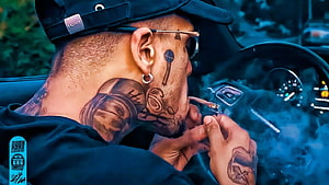 MC Kevin Smoking Cigar in Car with Face and Neck Tattoos HD wallpaper