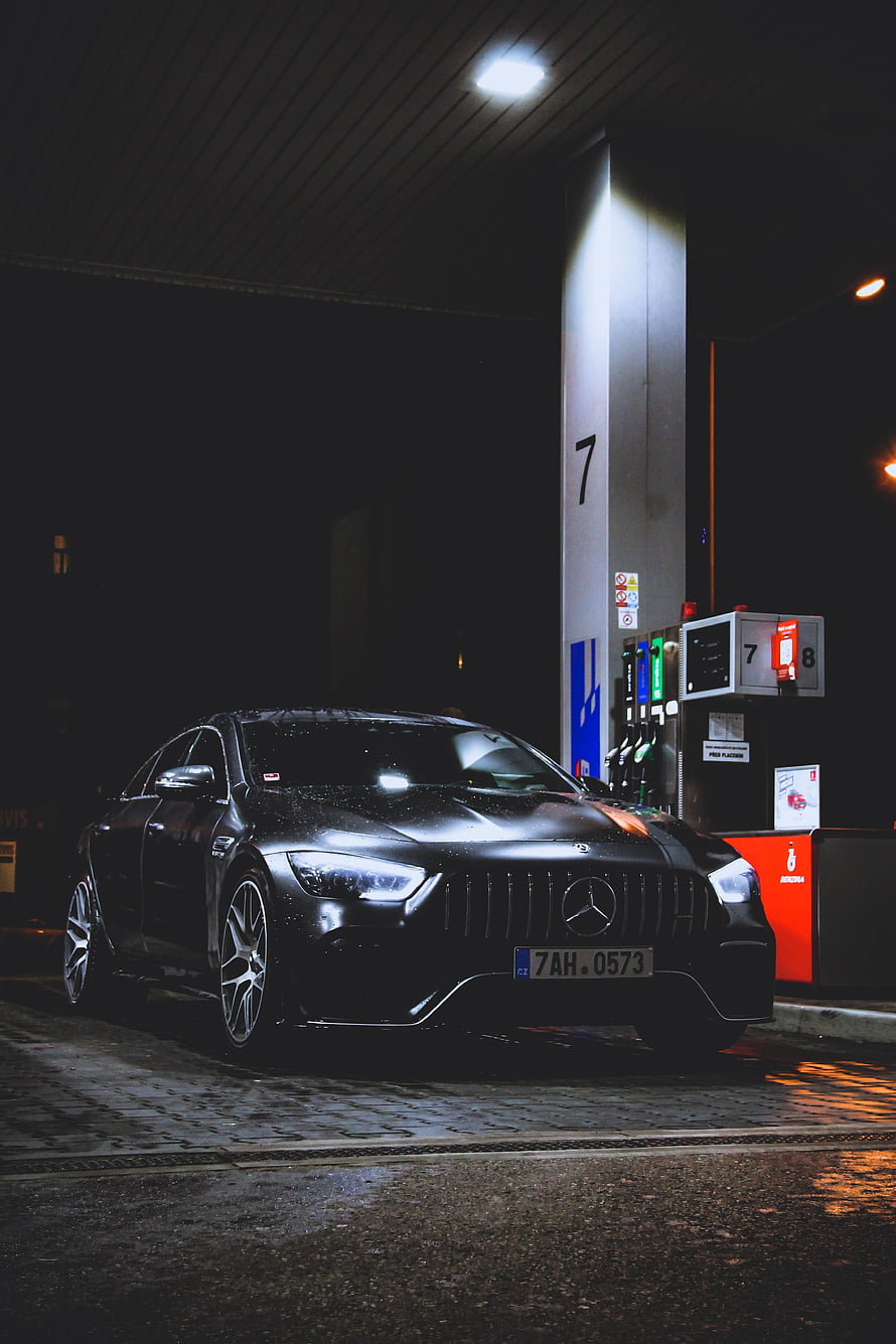 Black Mercedes-AMG GT Coupe Parked at a Gas Station at Night in the Rain HD phone wallpaper