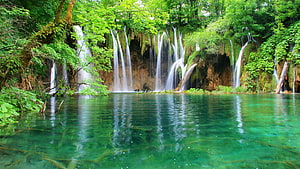 Serene Forest Waterfall Cascading Into a Crystal Clear Turquoise Pool HD wallpaper