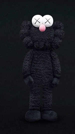 Black Kaws Companion Plush Figure with X Eyes and Pink Nose on Dark Background HD phone wallpaper