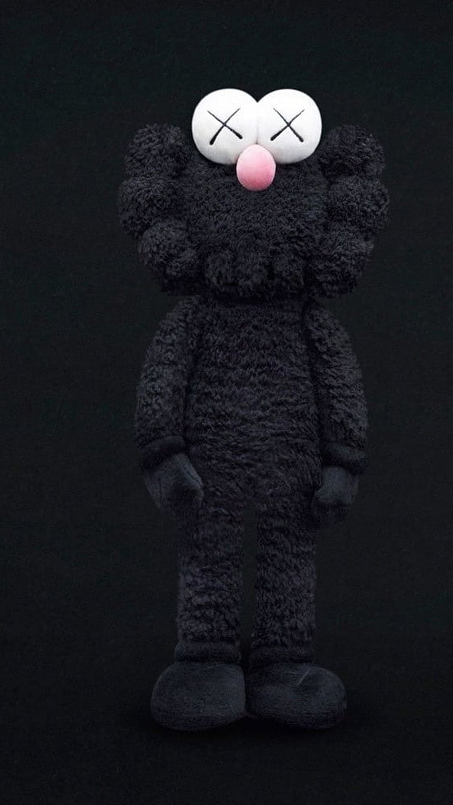Black Kaws Companion Plush Figure with X Eyes and Pink Nose on Dark Background HD phone wallpaper