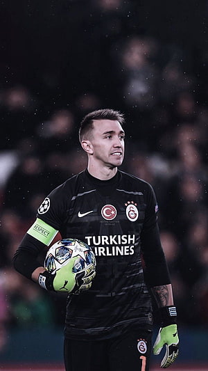 Fernando Muslera in Galatasaray Goalkeeper Kit Holding Champions League Ball HD phone wallpaper