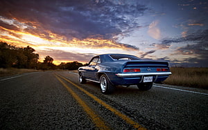 Blue Chevrolet Camaro SS parked on a rural road at sunset with dramatic clouds HD wallpaper