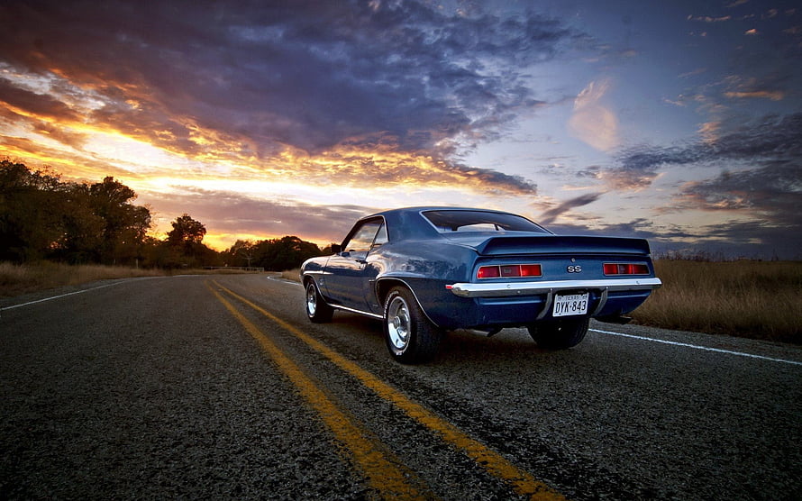 Blue Chevrolet Camaro SS parked on a rural road at sunset with dramatic clouds HD wallpaper