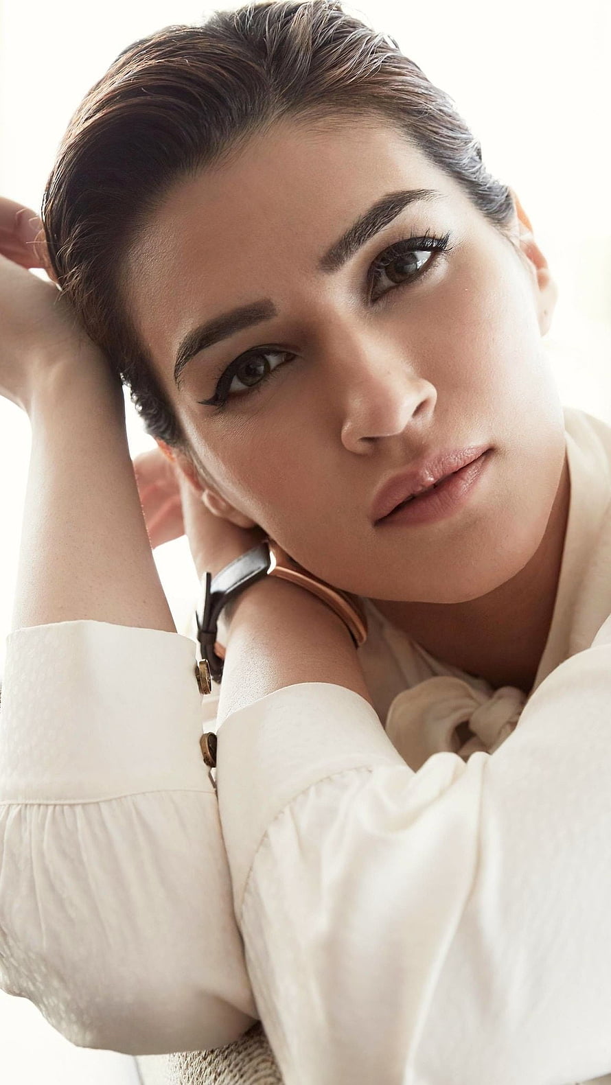 Kriti Sanon Close-Up Portrait in White Blouse with Slicked-Back Hair and Soft Studio Lighting HD phone wallpaper