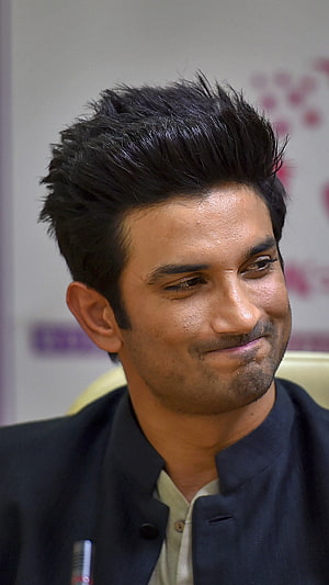 Sushant Singh Rajput in a dark bandhgala jacket with a subtle smile and styled hair HD phone wallpaper
