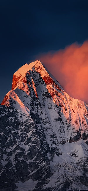 Alpenglow on a Snow-Capped Mountain Peak at Sunset with Dramatic Clouds HD phone wallpaper