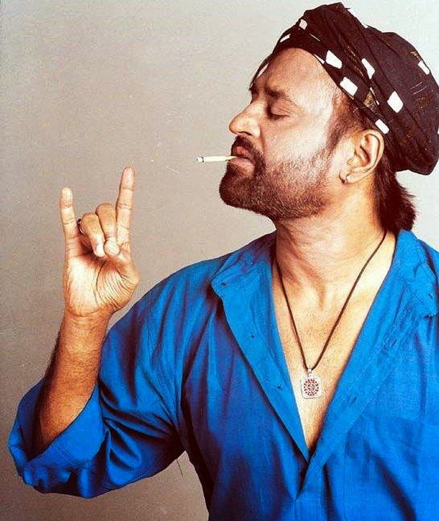 Rajinikanth in blue shirt and turban smoking a cigarette with hand gesture HD phone wallpaper