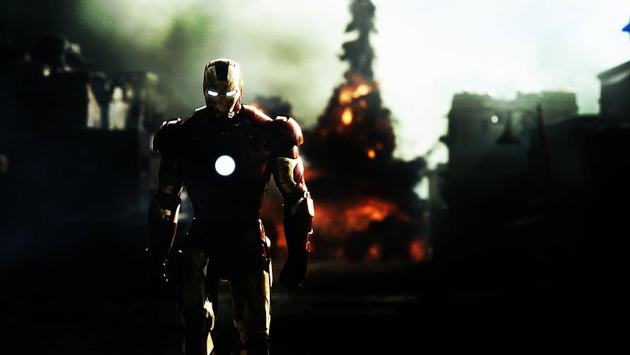 Iron Man Walking Through a War-Torn Battlefield with Explosions and Smoke HD wallpaper