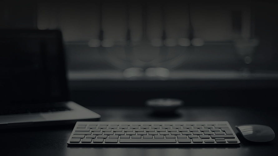 Minimalist Dark Workspace with Laptop, Keyboard, and Mouse on a Desk HD wallpaper