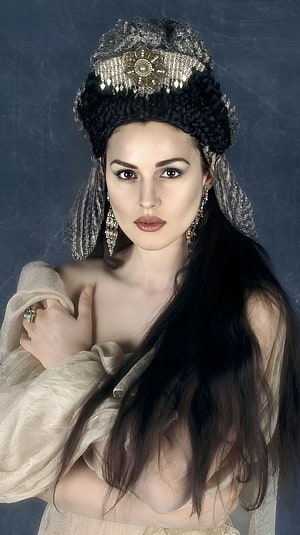 Monica Bellucci in ornate period costume with jeweled headdress and flowing dark hair HD phone wallpaper