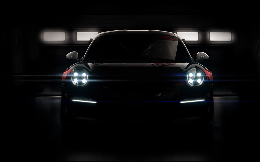 Porsche 911 GT3 R Front View With Glowing Headlights In Dark Garage Setting HD wallpaper