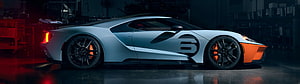 Ford GT Super Car Side Profile with Orange Accents in Dark Garage Setting HD wallpaper