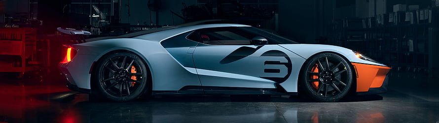 Ford GT Super Car Side Profile with Orange Accents in Dark Garage Setting HD wallpaper
