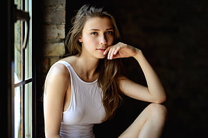 Young woman in white tank top sitting by a window with natural light and dark background, Beautiful, girl model HD wallpaper