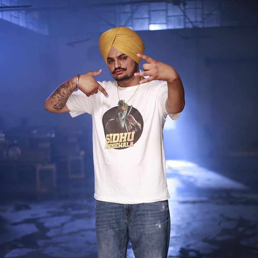 Sidhu Moose Wala in Yellow Turban and White T-Shirt in Industrial Setting HD wallpaper