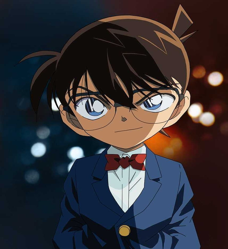 Conan Edogawa in a Blue Suit with Red Bow Tie and Glasses Against a Bokeh Background HD phone wallpaper