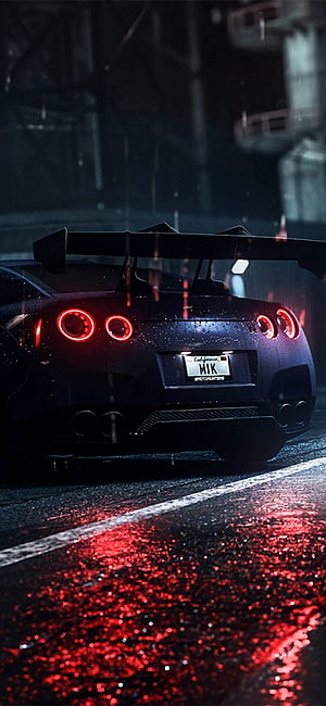 Nissan GT-R R35 Rear View in Rain with Red Taillights and Wet Asphalt Reflections HD phone wallpaper