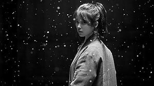 IU in a moody black and white portrait with falling snow particles HD wallpaper