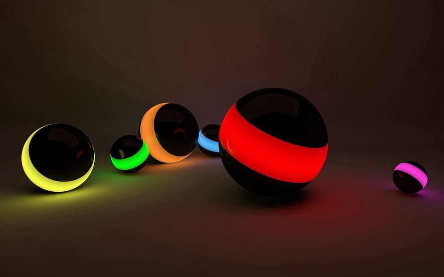 Glossy black spheres with glowing neon bands in red, yellow, green, blue, and pink on a dark surface HD wallpaper