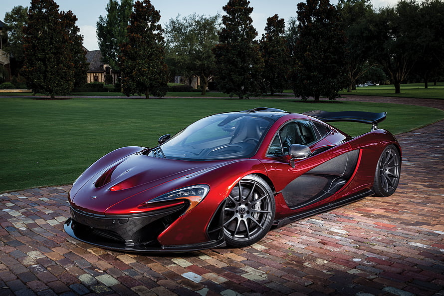 McLaren P1 Hypercar in Deep Red Parked on Cobblestone Driveway HD wallpaper