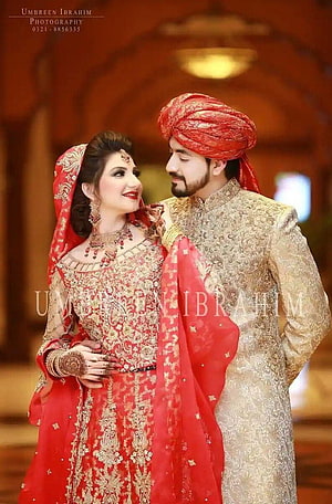 Elegant Indian Bridal Couple in Traditional Red and Gold Wedding Attire HD phone wallpaper