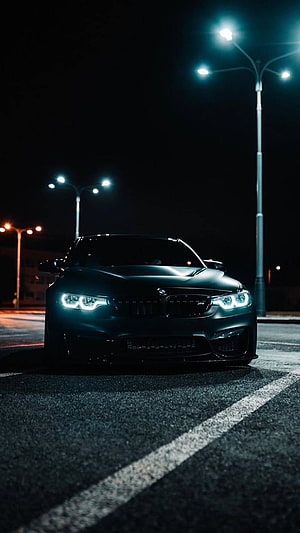 Matte Black BMW M4 F82 Front View With LED Headlights Parked On Night Street HD phone wallpaper