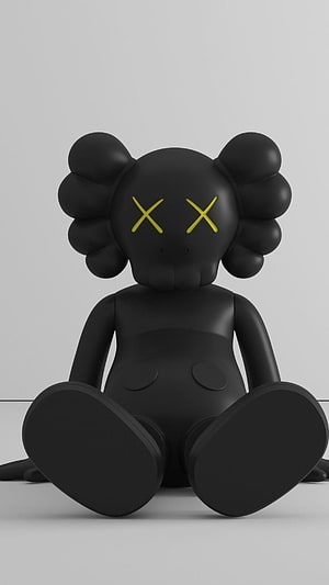KAWS Black Companion Figure with Yellow X Eyes Sitting on Minimalist White Background HD phone wallpaper