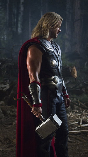 Thor in Asgardian Armor Holding Mjolnir in a Dark Forest Setting HD phone wallpaper