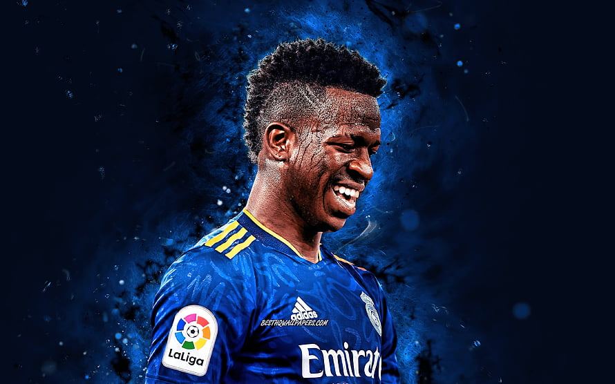 Vinicius Junior in Real Madrid Blue Kit with La Liga Badge and Neon Blue Background HD wallpaper