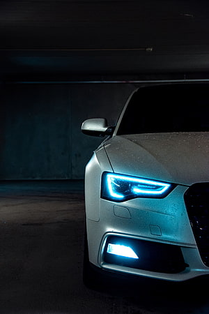 Audi A5 Front Headlight Detail with Blue LED Glow in Dark Parking Garage HD phone wallpaper