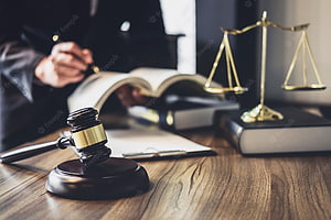 Judge's Gavel and Scales of Justice on a Wooden Desk with Legal Books HD wallpaper